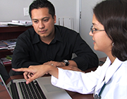 man and woman looking at laptop