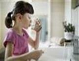 A little girl brushing her teeth.