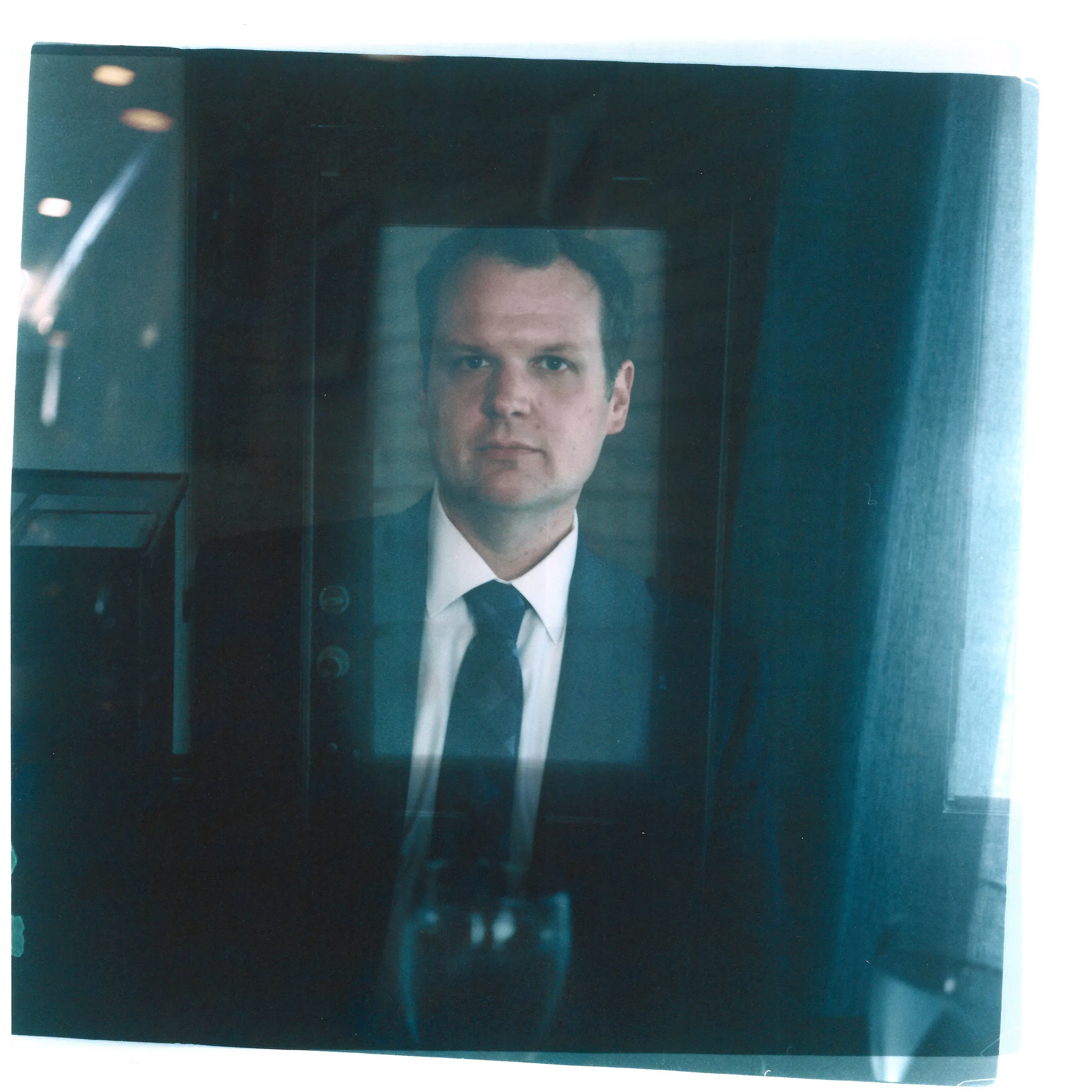 A double exposure made from  headshot of Hollan Holm layered with a photo of a front door.