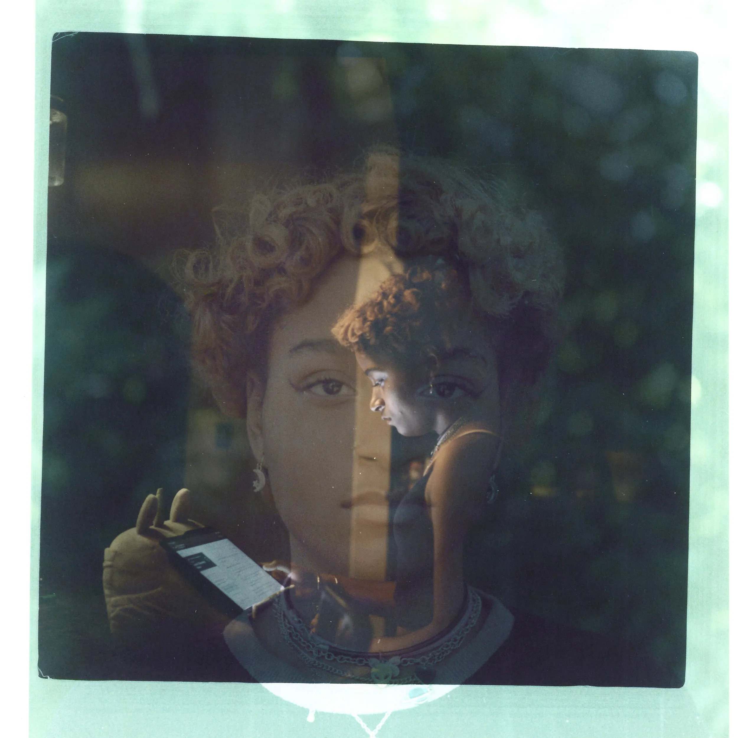 A double exposure made from a headshot of Navada Gwynn layered with a photo of her working on a tablet.