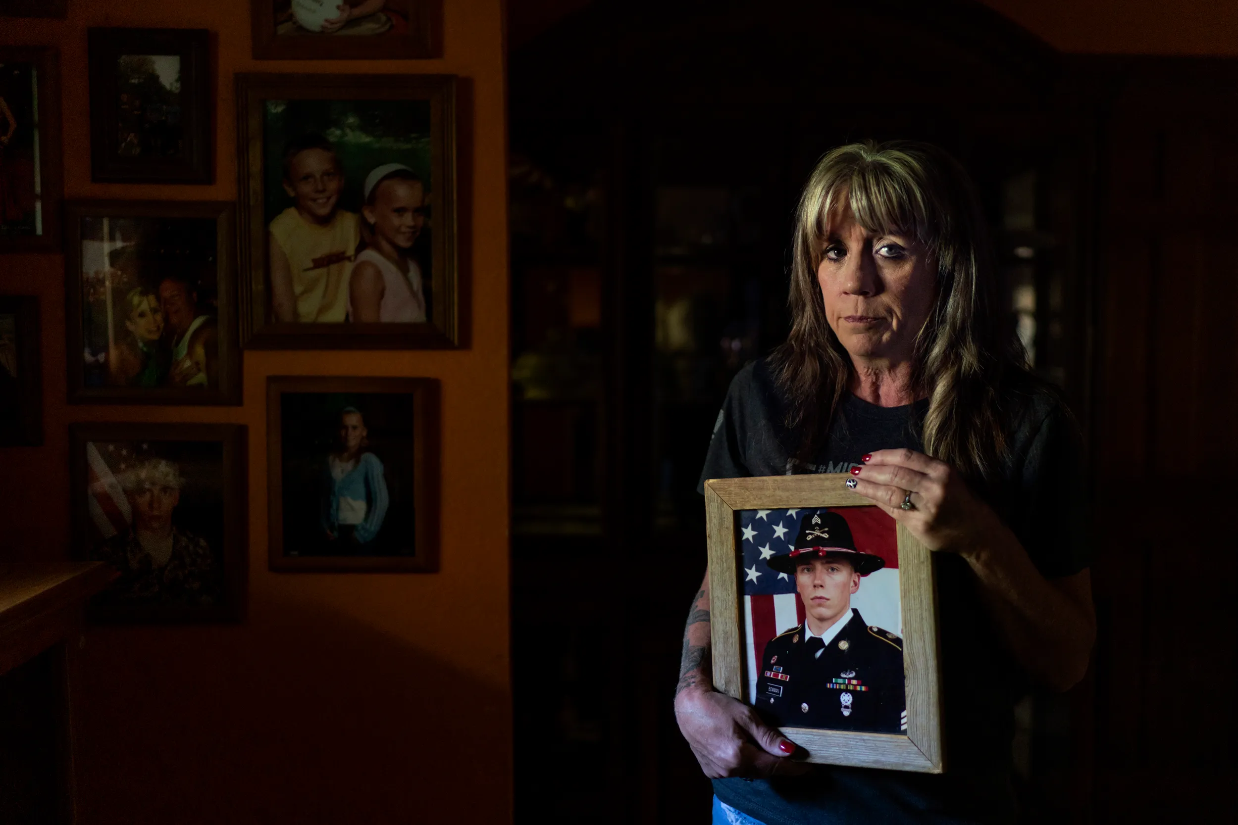 Barbie Rohde holding a photo of her son, Army Sgt. Cody Bowman.