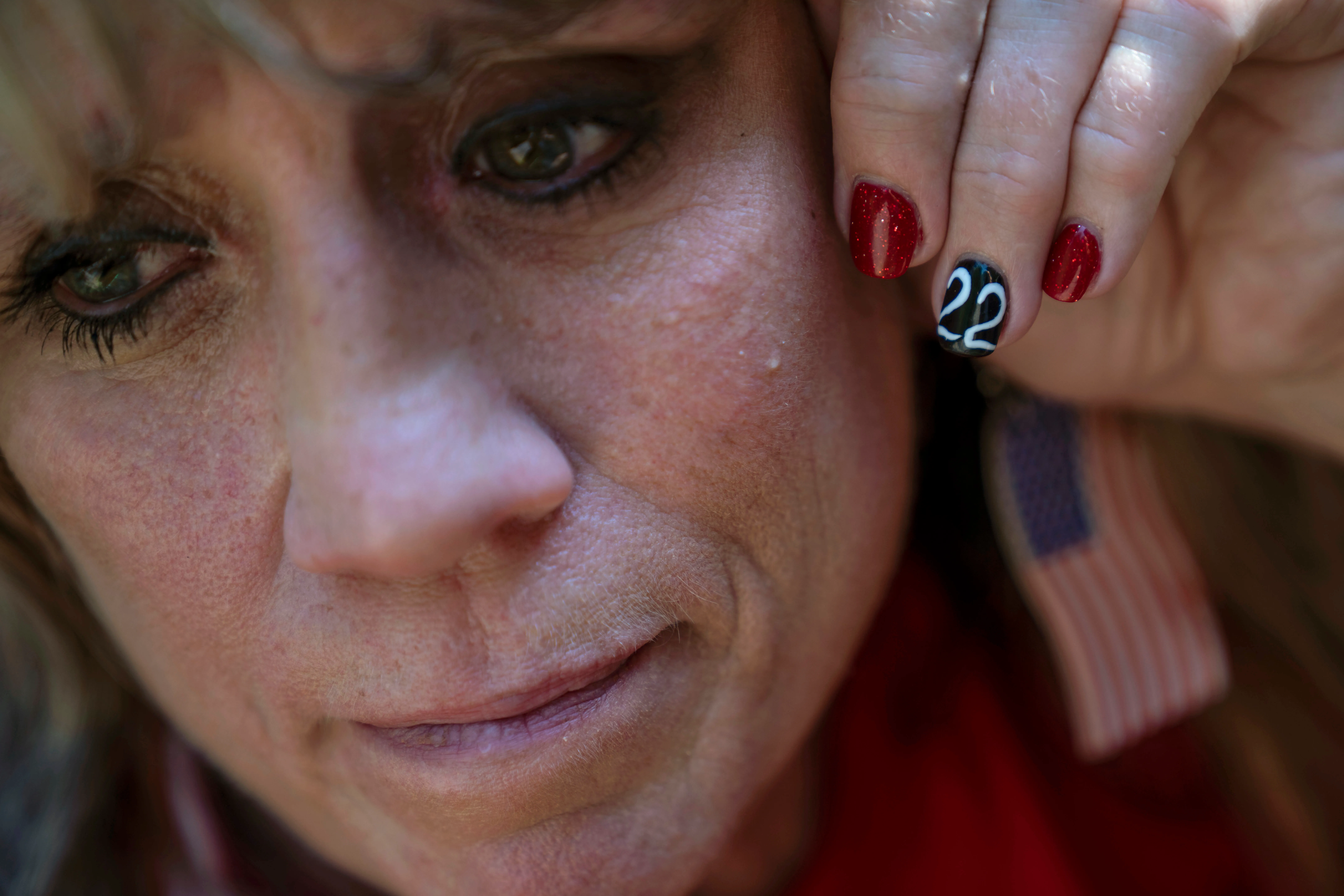 Barbie Rohde headshot with her fingernail decorated with the number 22.