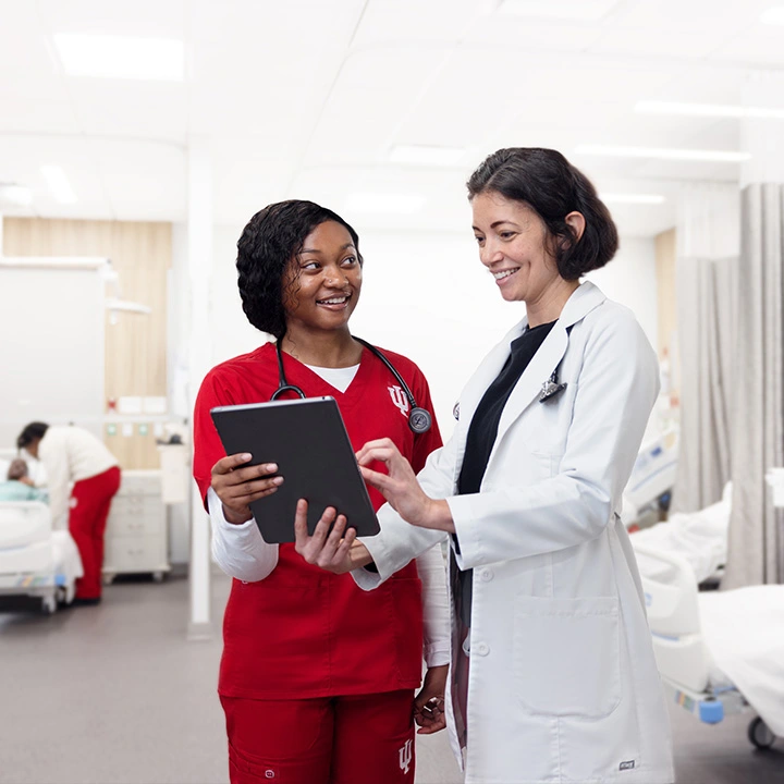 A medical student looks over a patients charts with her instructor.