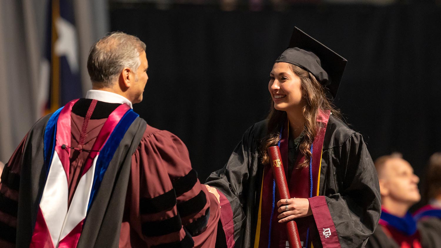 tamu-graduation-handshake-getting-diploma.jpg