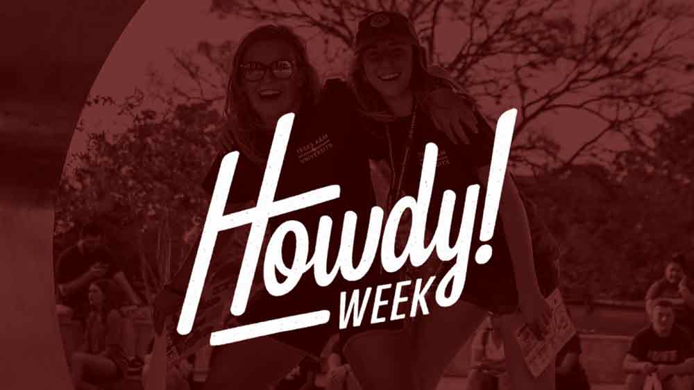 Two students standing inside of an Aggie Ring Statue during Howdy Week