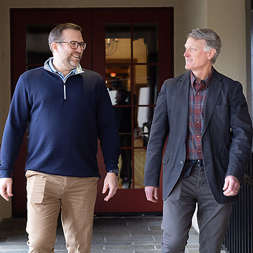 Michael Hastings and Richard Ottinger talking while walking outdoors